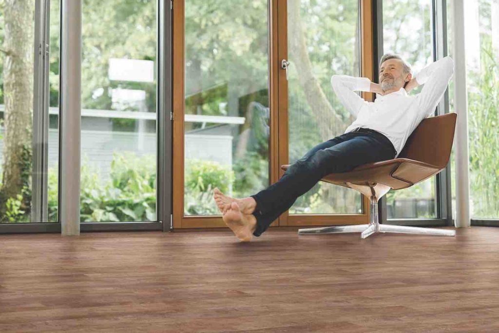 Man relaxing on chair in his living room